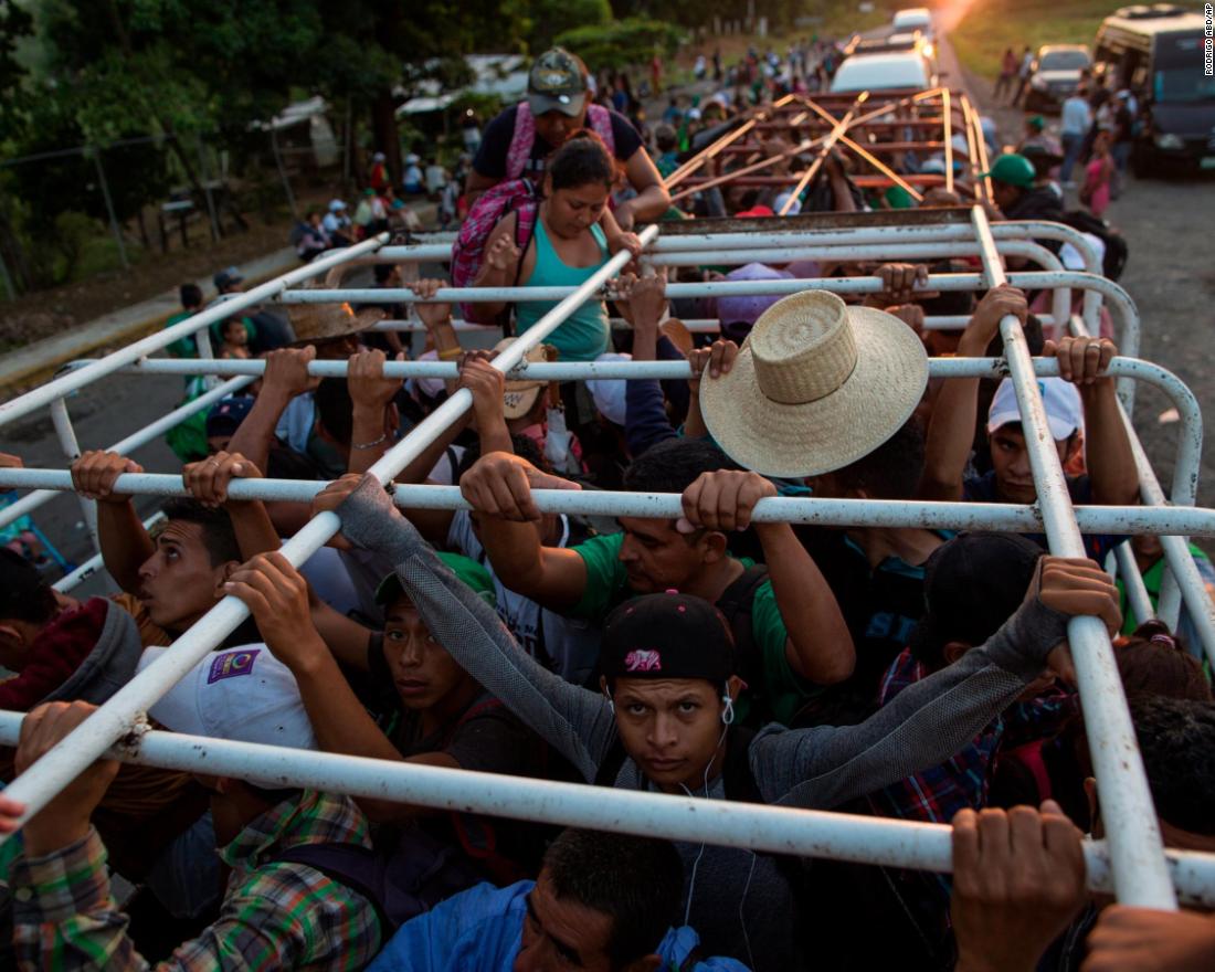 Migrants travel on a cattle truck, as a thousands-strong caravan of Central American migrants slowly makes its way toward the US border, between Pijijiapan and Arriaga, Mexico, on Friday, October 26.