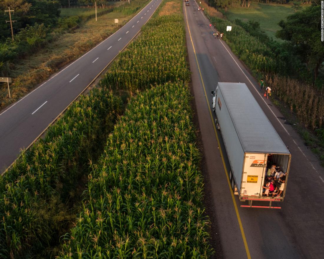 A truck of migrants heads in a caravan to the United States. Defense Secretary James Mattis is expected to sign deployment orders that could send 800 or more US troops to the border.