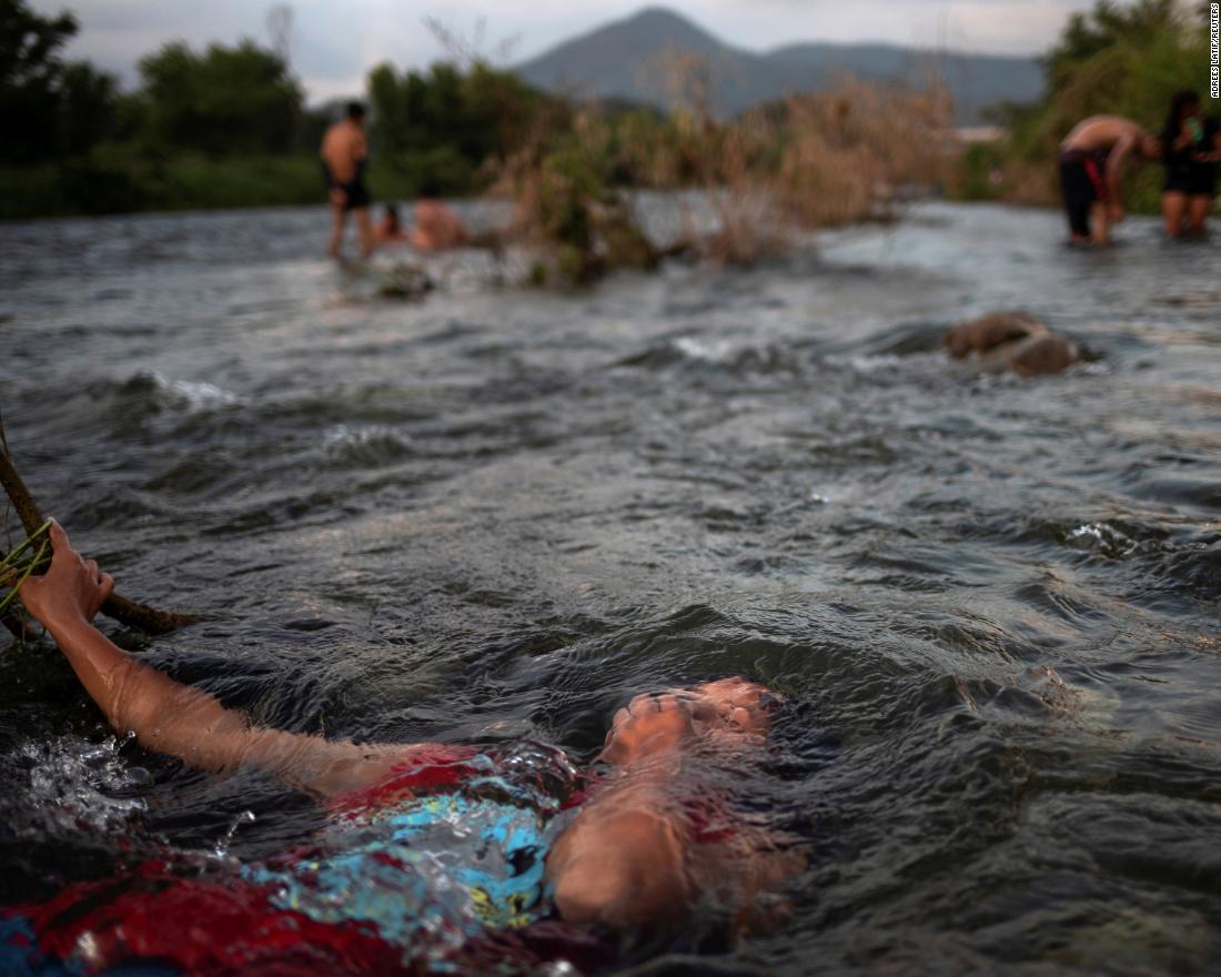 Jensi, a 14 year old migrant girl from Honduras, baths in a fresh water stream as she and others, part of caravan of thousands from Central America en route to the United States, take rest in Pijijiapan, Mexico on October 25.