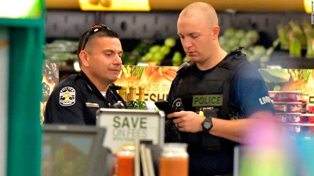 Members of the Louisville Metro Police Department talk inside the Kroger grocery store in Jeffersontown, Kentucky, after Wednesday&#39;s shootings.