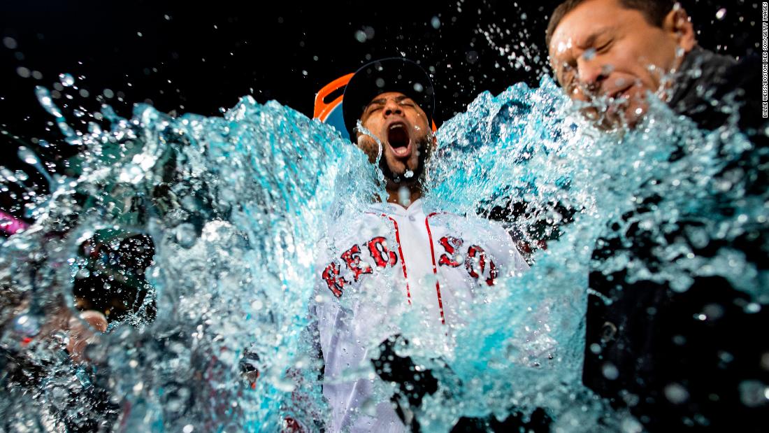 Eduardo Nuñez of the Boston Red Sox is doused with Gatorade after Boston&#39;s Game 1 win  at Fenway Park in Boston on Tuesday, October 23.
