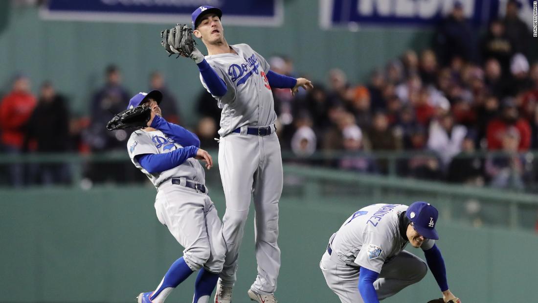 Cody Bellinger of the Los Angeles Dodgers narrowly avoids teammates Chris Taylor and Enrique Hernandez while making a catch during the sixth inning of Game 2.