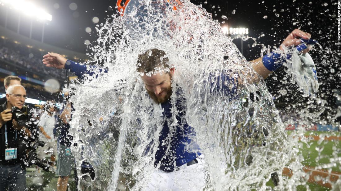 Max Muncy of the Dodgers is doused with water after his winning run in Game 4.