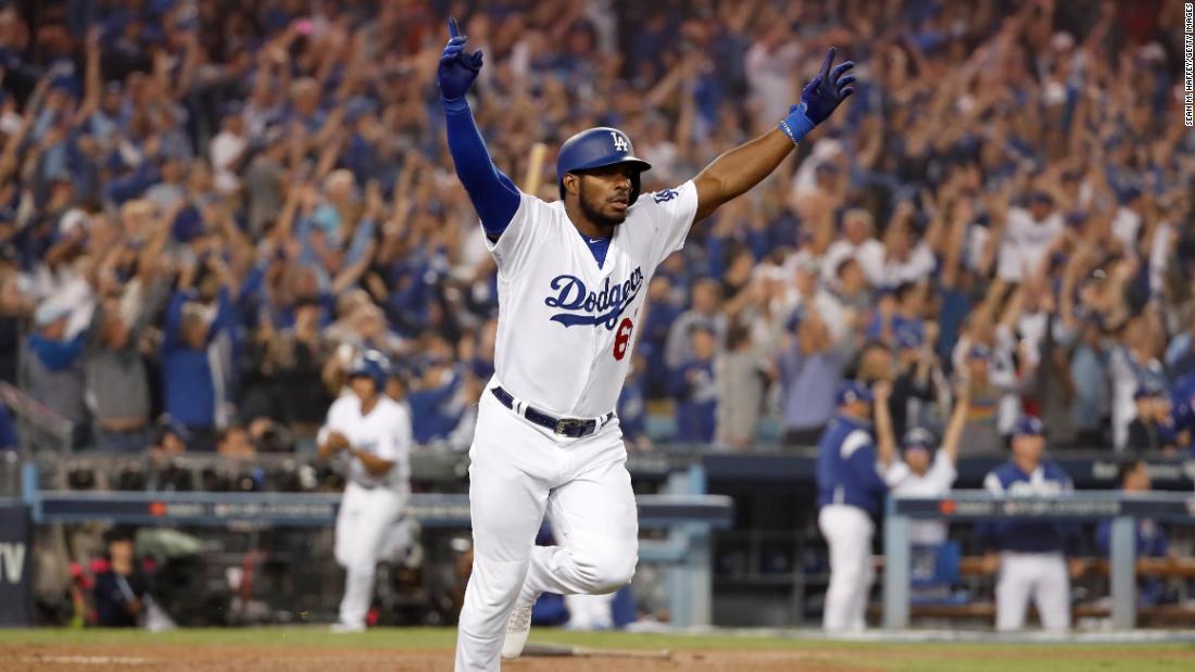 Yasiel Puig of the Dodgers celebrates on his way to first base after hitting a three-run home run to left field in the sixth inning of Game 4 of the series against Red Sox pitcher Eduardo Rodriguez at Dodger Stadium.