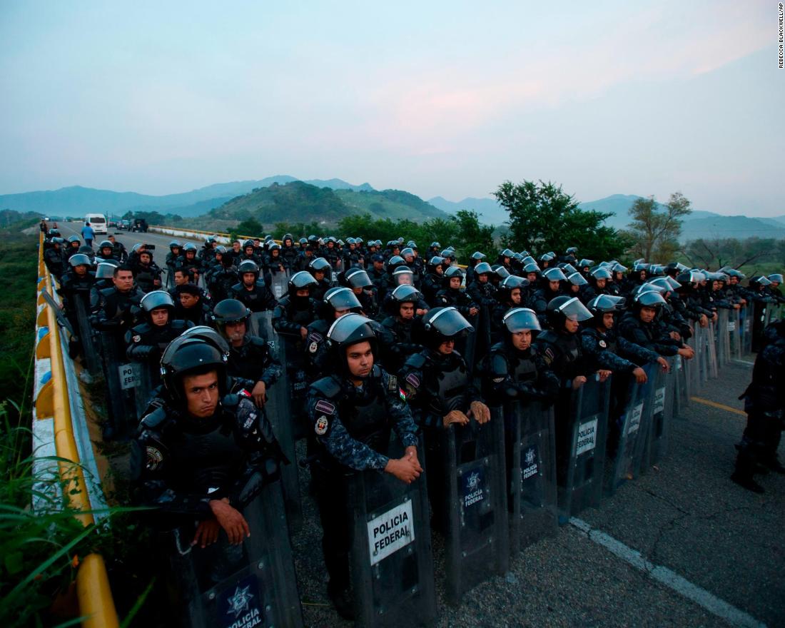 Police in riot gear block the highway to stop a caravan of thousands of Central American migrants from advancing through Mexico on Saturday.