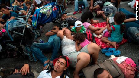 Members of a US-bound migrant caravan rest on a road between the Mexican states of Chiapas and Oaxaca after federal police briefly blocked them outside the town of Arriaga, Saturday, Oct. 27, 2018. Hundreds of Mexican federal officers carrying plastic shields had blocked the caravan from advancing toward the United States, after several thousand of the migrants turned down the chance to apply for refugee status and obtain a Mexican offer of benefits. (AP Photo/Rodrigo Abd)