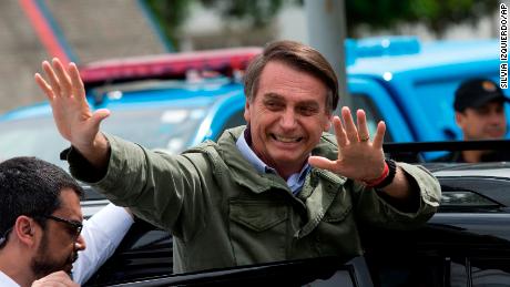 Jair Bolsonaro, presidential candidate with the Social Liberal Party, waves after voting in the presidential runoff election in Rio de Janeiro, Brazil, Sunday, Oct. 28, 2018. Bolsonaro is running against leftist candidate Fernando Haddad of the Workers&#39; Party. (AP Photo/Silvia izquierdo)