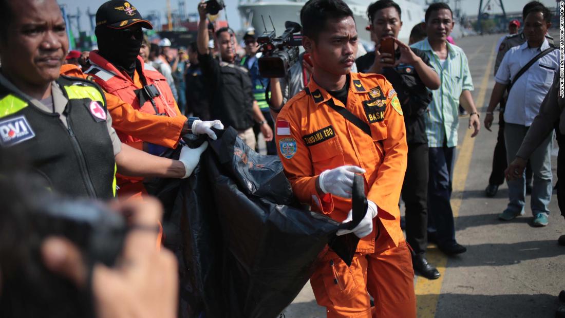 Rescue workers carry a body that was recovered from the waters near Jakarta on October 29.