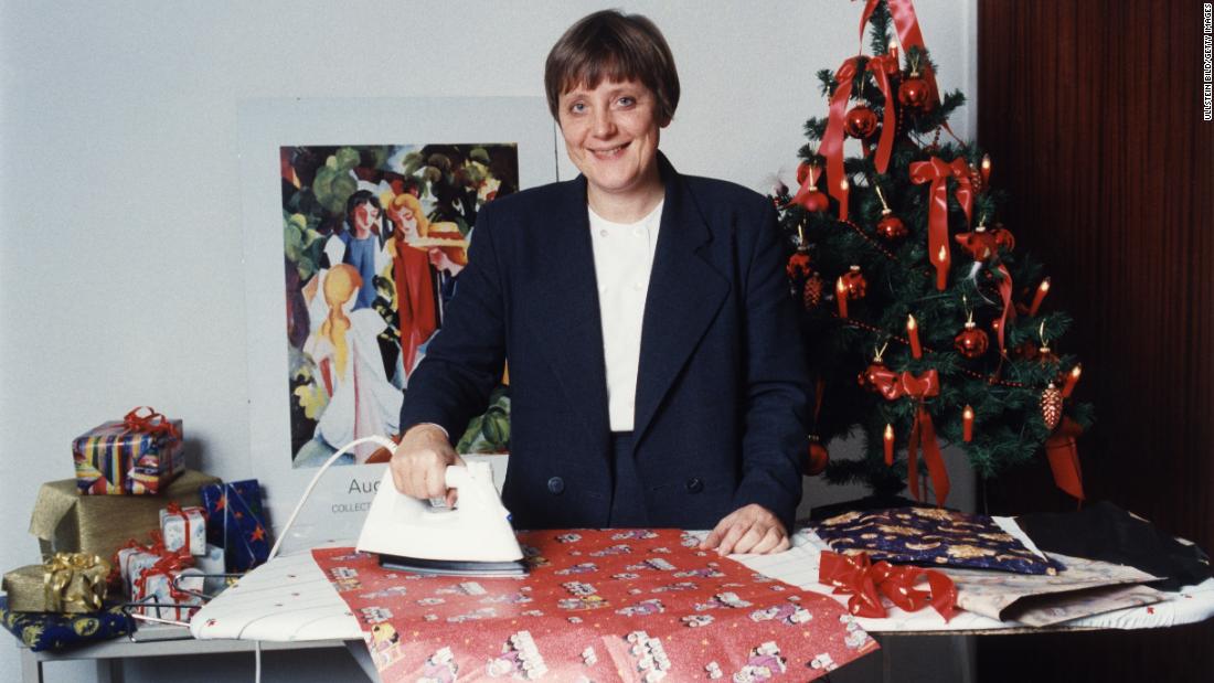 Merkel, as the country&#39;s leader on environmental issues, irons wrapping paper to show how it can be recycled.