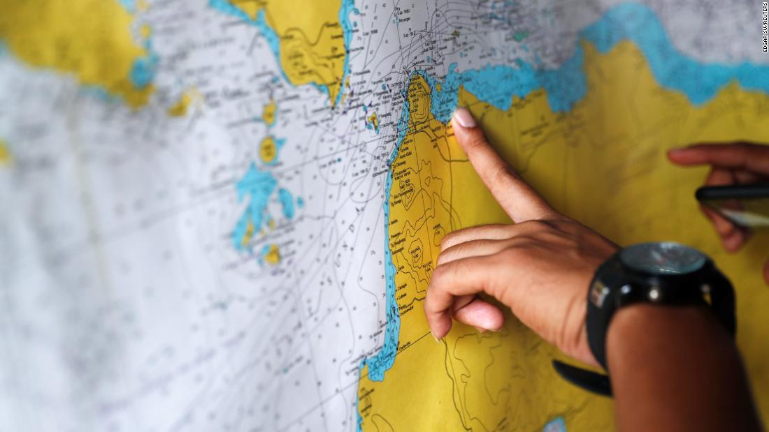 A police officer studies a map in the search-and-rescue command center.