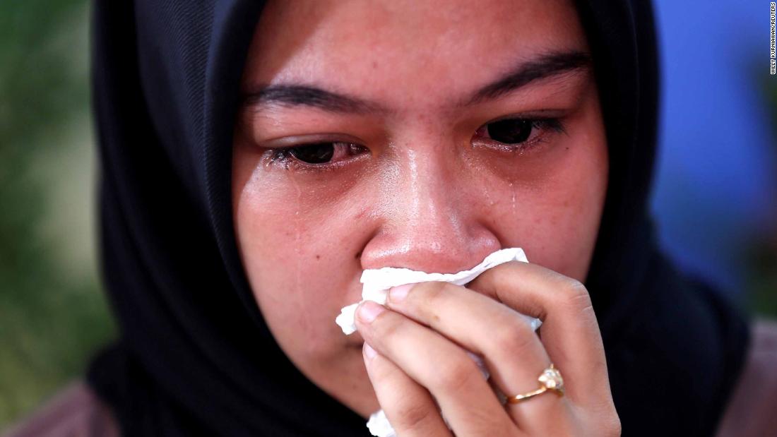 A relative of a passenger cries at a hospital in Jakarta.