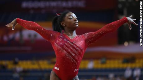 Simone Biles led the US to a record win in the team event and qualified for all five individual finals.