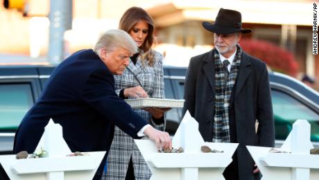 The Trumps put down stones from the White House at a memorial for those killed in the massacre.