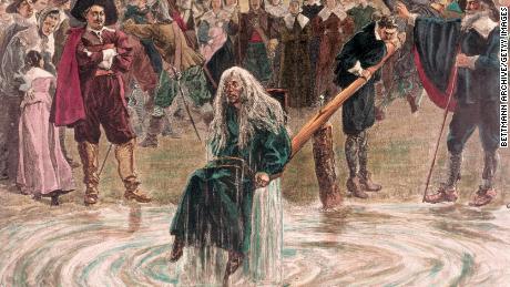 An accused witch going through the judgment trial, where she is dunked in water to prove her guilt of practicing witchcraft.