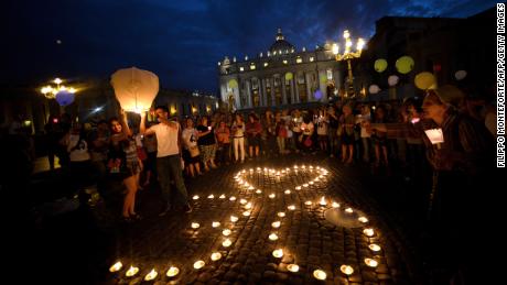 Demonstrators stand by candles shaping a heart and the number 30 as they coomemorate the 30th anniversary of Emanuela Orlandi disappearance in Saint Peter's Square at the Vatican on June 22, 2013