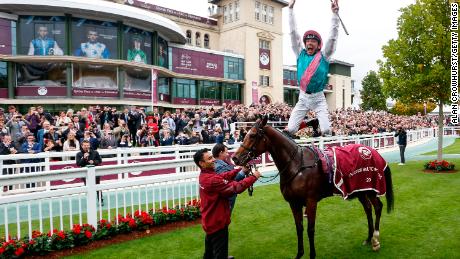 Dettori celebrates in trademark style after his win on Enable in Paris.