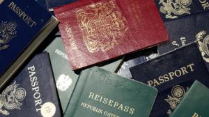 SAN FRANCISCO - JUNE 14:  Counterfeit passports are shown at San Francisco International Airport June 14, 2002 in California. At more than 300 ports of entry across the U.S., a new system known as DataShare is being used to enable U.S. Immigration and Naturalization Service (INS) inspectors to see biographical information and photographs of visa holders who receive their documents at consular posts around the world.  (Photo by Justin Sullivan/Getty Images)