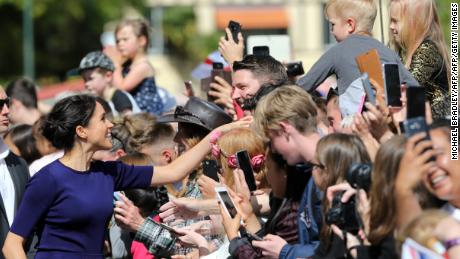 Meghan, Duchess of Sussex shakes the hand of a young boy during a public walkabout at the Rotorua Government Gardens.