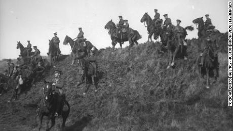 October 1915: Canadian cavalry undergo training at Shorncliffe during World War I, riding their horses down the steep slope of a hill. 