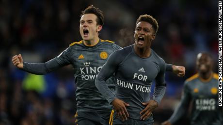 Demarai Gray celebrates with teammate Ben Chilwell, revealing a commemorative message for Vichai Srivaddhanaprabha during the Premier League match between Cardiff City and Leicester City.