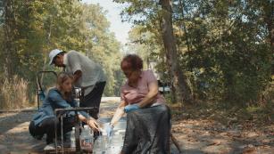 CNN&#39;s Sara Ganim, left, with Denmark residents Eugene Smith and Paula Brown. They drive 20 miles round-trip to fill empty bottles with natural spring water to use at home.