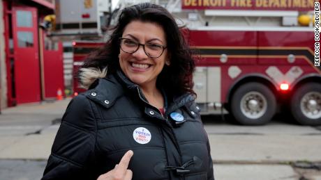 Rashida Tlaib points to her 'I voted' sticker after voting during the midterm election in Detroit.