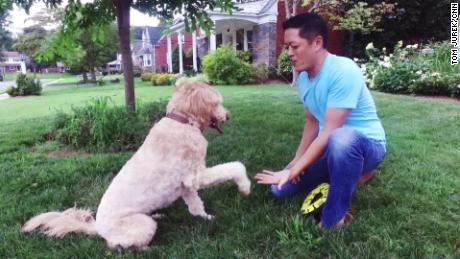 Kevin Yu plays with his dog three years after IBS sent him to the ER. 