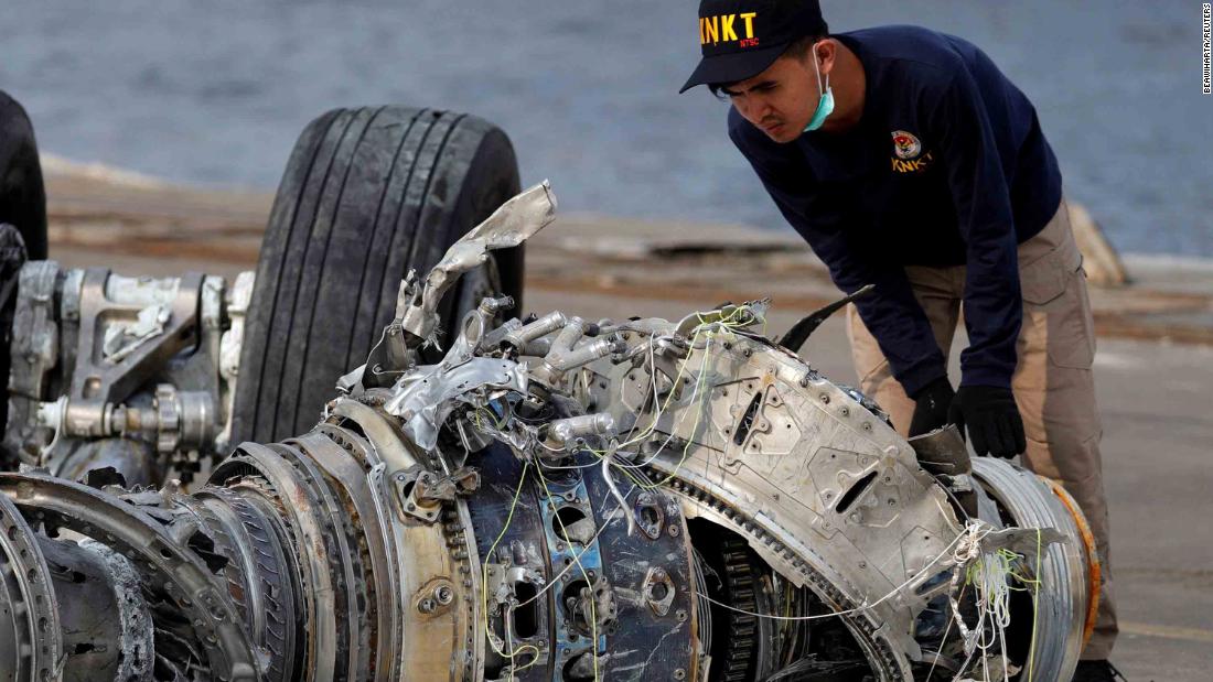 An Indonesian official examines a turbine engine from the plane on Sunday, November 4.