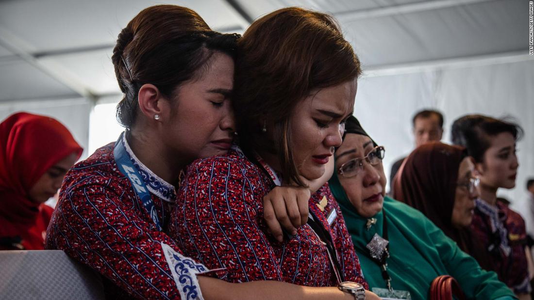 Victims&#39; families and colleagues react on a Navy ship as they&#39;re ferried to the crash site on November 6.