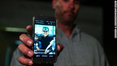 Jason Coffman displays a photo of his son Cody outside the Thousands Oaks Teen Center.