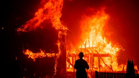 A home burns as the Camp Fire rages through Paradise.