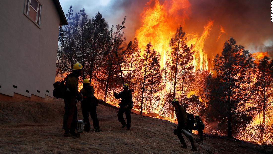 Firefighters monitor a back fire while attempting to save homes in Paradise on November 8. 