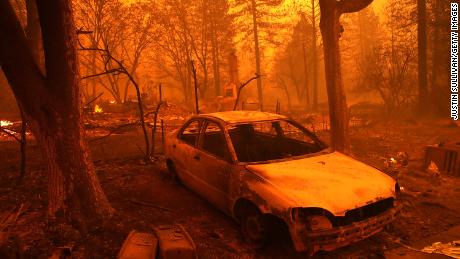 PARADISE, CA - NOVEMBER 08:  A burned out car sits in front of a home that burned as the Camp Fire moves through the area on November 8, 2018 in Paradise, California. Fueled by high winds and low humidity, the rapidly spreading Camp Fire has ripped through the town of Paradise and has quickly charred 18,000 acres and has destroyed dozens of homes in a matter of hours. The fire is currently at zero containment.  (Photo by Justin Sullivan/Getty Images)