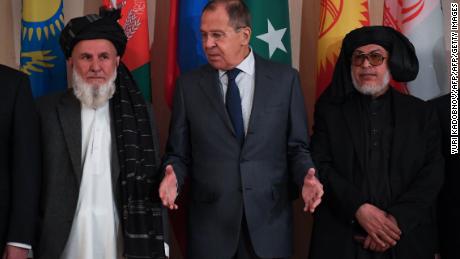 Russian Foreign Minister Sergei Lavrov, center, and representatives of both the Afghan government and the Taliban pose for a photo in Moscow on November 9.