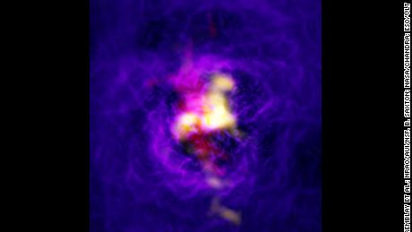 A composite image showing the fountain-like flow of gas powered by the supermassive black hole in the central galaxy. 