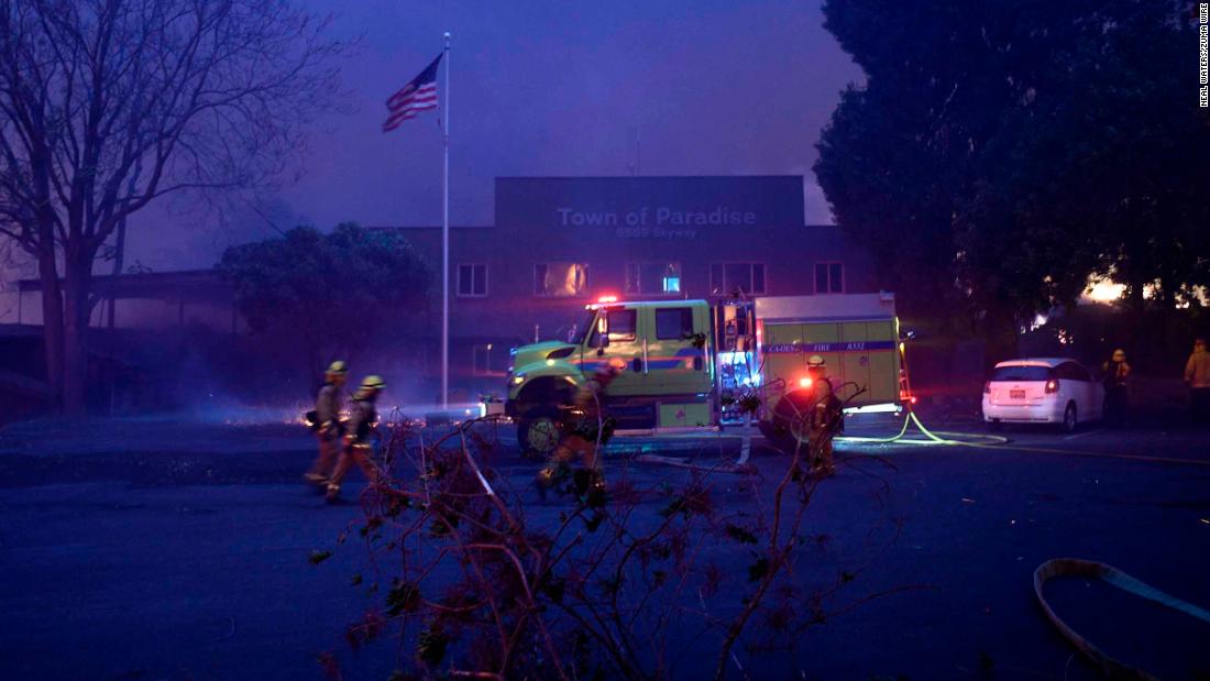 A fire emergency crew works to protect the Paradise Town Hall from the encroaching Camp Fire on November 8.