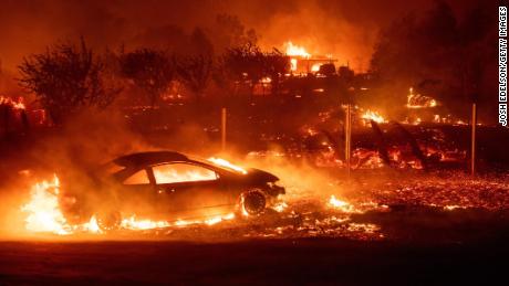 Vehicles and homes burn as the Camp Fire tears through Paradise, California on November 8.
