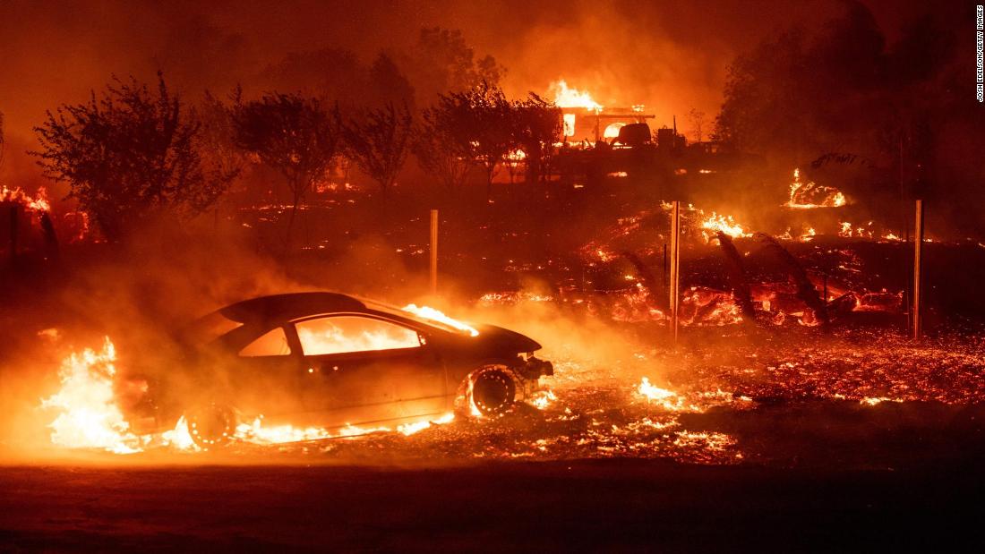 Vehicles and homes burn as the Camp Fire rips through Paradise on November 8.