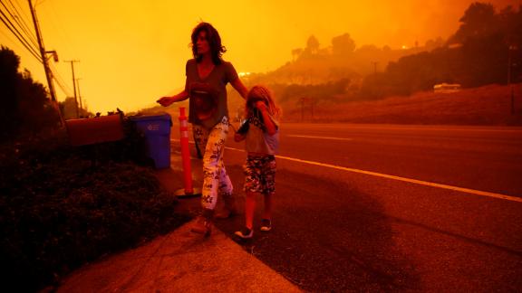 Gabi and Jonah Frank walk on the Pacific Coast Highway as the Woolsey Fire threatens their Malibu home on November 9.