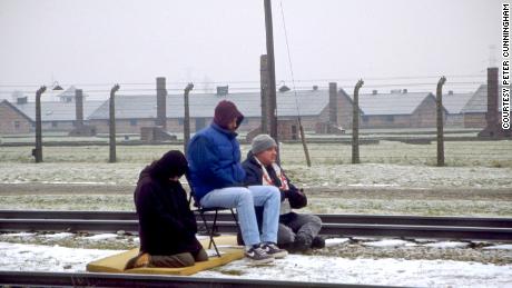 Glassman and other Zen Peacemakers meditate on the train tracks at Auschwitz. Photo by Peter Cunningham. 