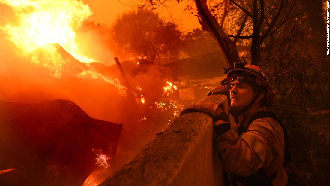 Malibu Mayor Rick Mullen, who is also a firefighter, surveys a house engulfed in flames on Friday, November 9.