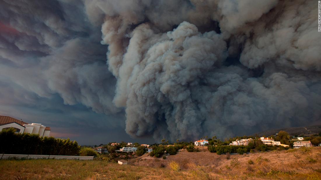 A massive smoke plume, powered by strong winds, rises above the Woolsey Fire in Malibu on November 9.