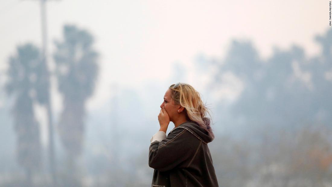 A woman in Malibu reacts to devastation on November 9.