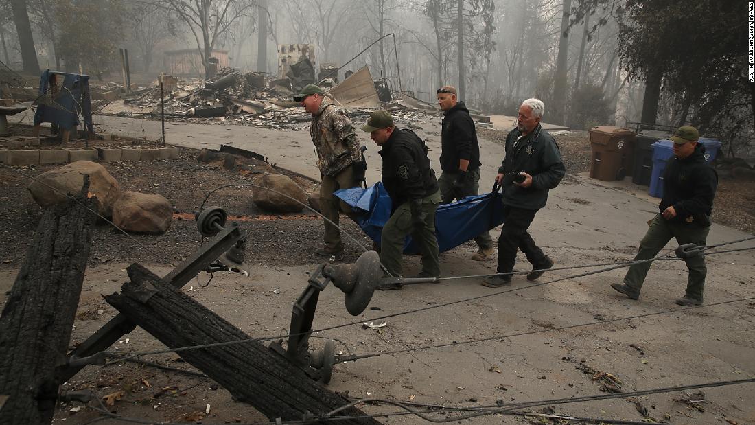 Sheriff&#39;s deputies carry a body bag with a Camp Fire victim on November 10.