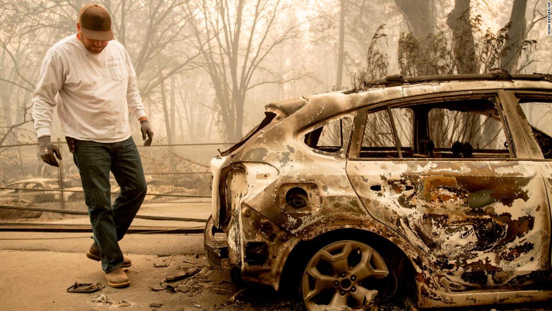 Eric England searches through a friend&#39;s vehicle in Paradise on November 10.