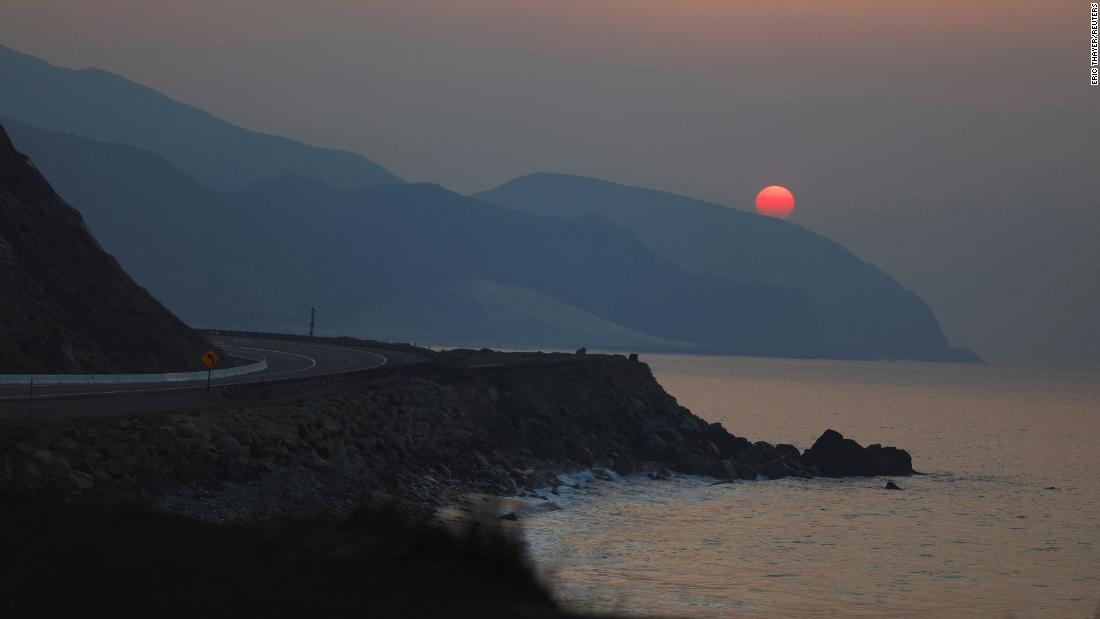 The sun rises over the Pacific Ocean on November 11 as the Woolsey Fire burns in Malibu.