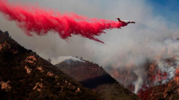 A plane drops fire retardant on a burning hillside in Malibu on November 11.