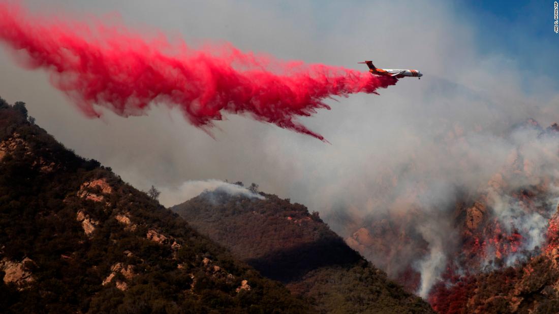 A plane drops fire retardant on a burning hillside in Malibu on November 11.