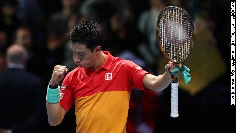 Japan's Kei Nishikori celebrates match point against Roger Federer of Switzerland during Day One of the Nitto ATP World Tour Finals.