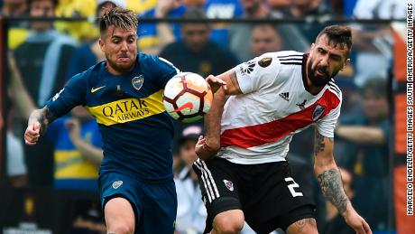 Julio Buffarini of Boca Juniors fights for the ball with River Plate's Lucas Pratto.